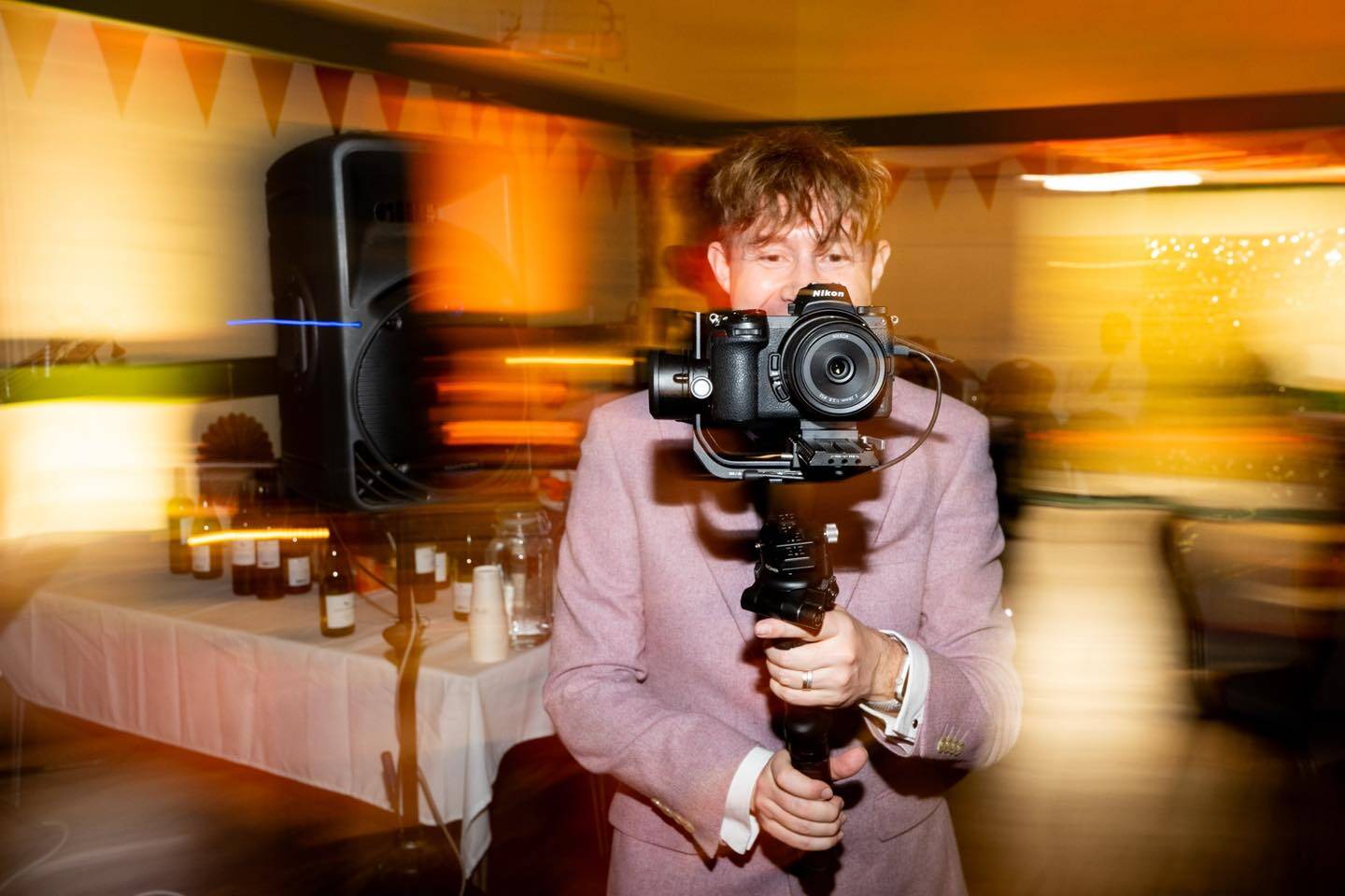 Ben, the Norfolk wedding photographer and videographer behind Nimble, holding a camera