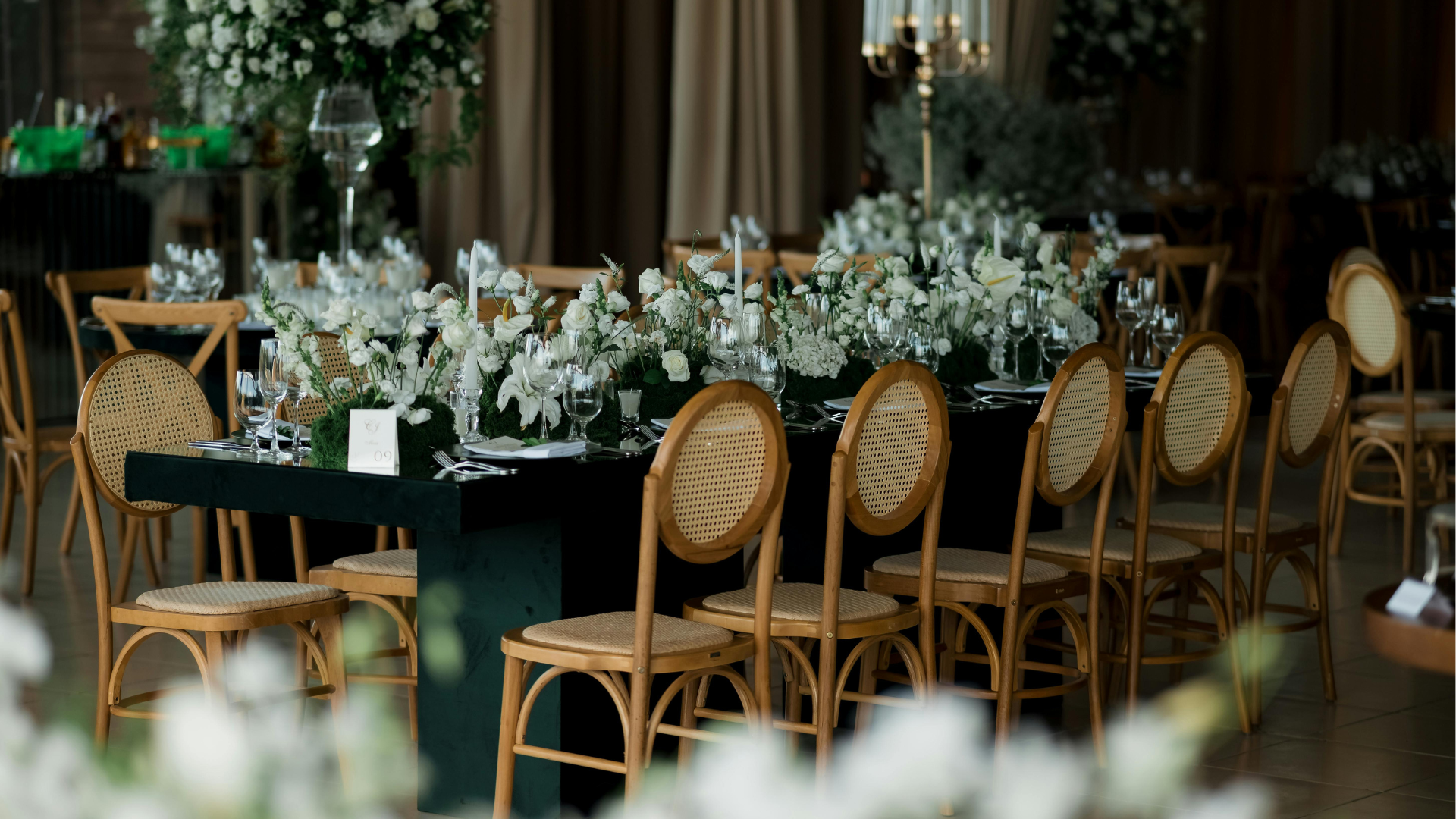 Elegant indoor wedding breakfast setup with flowers, candles and warm winter styling